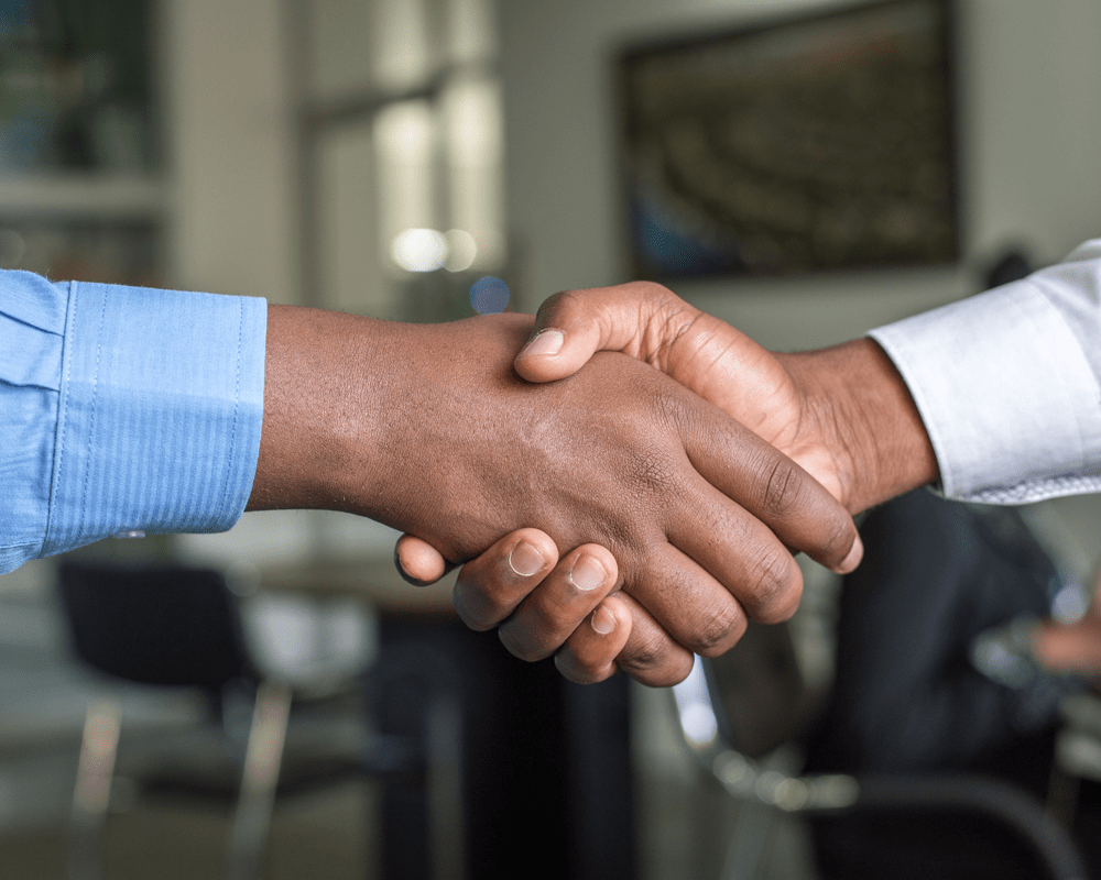 Two candidates greeting each other with a hand shake